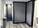 Hallway featuring modern gray walls and flooring with attractive black trim at 1417 N Belleview Pl, Indianapolis, IN 46222