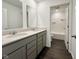 Bright bathroom with double sink vanity, a large mirror, and a combined tub and shower at 1534 Trichel Dr, Greenwood, IN 46143