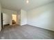 Spacious bedroom with soft carpet, neutral walls, and access to an en-suite bathroom, ensuring comfort and convenience at 1534 Trichel Dr, Greenwood, IN 46143
