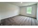 Cozy bedroom with plush carpet, a bright window with nature views, and fresh neutral walls, creating a serene space at 1534 Trichel Dr, Greenwood, IN 46143