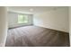 Spacious bedroom featuring neutral carpeting, a window with natural light, and white trim at 1534 Trichel Dr, Greenwood, IN 46143
