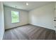 Comfortable bedroom with soft carpet, a large window with natural light, and fresh neutral walls, offering a relaxing retreat at 1534 Trichel Dr, Greenwood, IN 46143