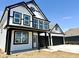 Two-story home featuring a black-and-white exterior, black trim, and an attached two-car garage at 1534 Trichel Dr, Greenwood, IN 46143