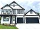Two-story home with a modern farmhouse design, black trim, and an attached two-car garage at 1534 Trichel Dr, Greenwood, IN 46143