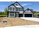 Charming two-story home boasting a modern black and white exterior design with attached garage at 1534 Trichel Dr, Greenwood, IN 46143