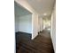 Inviting hallway with hardwood floors leads to a spacious open area, offering a seamless transition between rooms at 1534 Trichel Dr, Greenwood, IN 46143