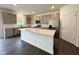Modern kitchen with stainless steel appliances, a large island with a stone countertop, and ample cabinet space at 1534 Trichel Dr, Greenwood, IN 46143