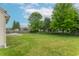 Expansive backyard featuring a well-maintained lawn, a deck, mature trees, and secure fencing at 1603 Quinn Creek Dr, Brownsburg, IN 46112