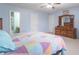 Bright bedroom with a ceiling fan, natural light, and neutral carpeting at 1603 Quinn Creek Dr, Brownsburg, IN 46112