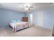 Neutral bedroom with a ceiling fan and a colorful quilt on the bed at 1603 Quinn Creek Dr, Brownsburg, IN 46112