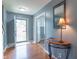Warm and inviting foyer showcasing hardwood floors, stylish decor, and ample natural light from the front door at 1603 Quinn Creek Dr, Brownsburg, IN 46112