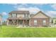 Charming two-story home boasts a well-manicured lawn, a cozy front porch, and classic curb appeal at 1603 Quinn Creek Dr, Brownsburg, IN 46112