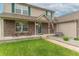 Quaint front porch with rocking chairs, an American flag, and a beautifully landscaped yard, creating a warm entrance at 1603 Quinn Creek Dr, Brownsburg, IN 46112