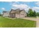 Spacious three-car garage with a basketball hoop and a well-maintained lawn, providing ample parking at 1603 Quinn Creek Dr, Brownsburg, IN 46112