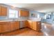 Charming kitchen featuring wooden cabinets, stainless steel dishwasher, and an abundance of natural light at 1603 Quinn Creek Dr, Brownsburg, IN 46112