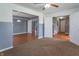 Open-concept living room with neutral paint, carpet flooring, and convenient access to multiple rooms at 1603 Quinn Creek Dr, Brownsburg, IN 46112