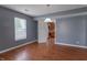Well-lit room featuring wood floors, access to the kitchen and natural light at 1603 Quinn Creek Dr, Brownsburg, IN 46112