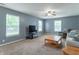 Comfortable living room featuring ample seating, a ceiling fan, and abundant natural light from the windows at 1603 Quinn Creek Dr, Brownsburg, IN 46112
