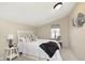 Comfortable bedroom with a queen bed, stylish decor, and a window seat at 1609 S G St, Elwood, IN 46036