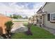 Charming home with green front yard featuring professional landscaping and a covered front porch at 1609 S G St, Elwood, IN 46036