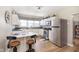 Updated kitchen features white cabinets, stainless appliances, and breakfast bar at 1609 S G St, Elwood, IN 46036