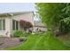 Spacious backyard features an outdoor patio, lush greenery, and mature trees at 1614 Rosebud Ln # 83, Greenwood, IN 46143