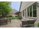 Brick house backyard with a patio set with furniture and luscious landscaping at 1614 Rosebud Ln # 83, Greenwood, IN 46143