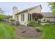 Spacious backyard featuring a brick house, lush lawn, and well-maintained landscaping at 1614 Rosebud Ln # 83, Greenwood, IN 46143