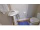 Elegant pedestal sink and toilet create a simple powder room with modern fixtures at 1614 Rosebud Ln # 83, Greenwood, IN 46143