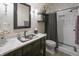 The bathroom offers a stylish vanity with marble countertops and a tiled walk-in shower at 1614 Rosebud Ln # 83, Greenwood, IN 46143