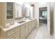 Elegant bathroom boasting dual sinks, granite countertops, wood-style accent wall, and ample cabinet space at 1614 Rosebud Ln # 83, Greenwood, IN 46143