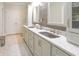 Elegant bathroom boasting dual sinks, granite countertops, wood-style accent wall, and ample cabinet space at 1614 Rosebud Ln # 83, Greenwood, IN 46143