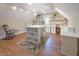 Spacious bonus room with built-in shelving, a rocking chair, and ample natural light at 1614 Rosebud Ln # 83, Greenwood, IN 46143
