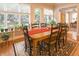 Inviting dining room with large windows, plants, and a wooden table set for Gathering gatherings at 1614 Rosebud Ln # 83, Greenwood, IN 46143