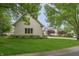 Landscaped front yard with a two story brick house and trimmed trees at 1614 Rosebud Ln # 83, Greenwood, IN 46143