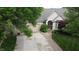 Inviting home with a neatly manicured lawn, mature trees, and a two-car garage at 1614 Rosebud Ln # 83, Greenwood, IN 46143