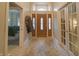 Elegant foyer features tile flooring, and a beautiful wooden door with transom window at 1614 Rosebud Ln # 83, Greenwood, IN 46143