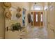 Elegant foyer features tile flooring, and a beautiful wooden door with transom window at 1614 Rosebud Ln # 83, Greenwood, IN 46143