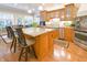 Bright kitchen showcasing a granite island, wood cabinets, stainless appliances, and a view of backyard at 1614 Rosebud Ln # 83, Greenwood, IN 46143