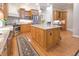 Spacious kitchen featuring granite countertops, stainless steel appliances, island, and wood cabinetry at 1614 Rosebud Ln # 83, Greenwood, IN 46143
