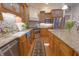 Beautiful kitchen with stainless steel appliances, granite countertops, wood cabinets and center island at 1614 Rosebud Ln # 83, Greenwood, IN 46143