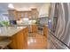 Well-equipped kitchen with stainless steel appliances, granite countertops, wooden cabinets, and tile backsplash at 1614 Rosebud Ln # 83, Greenwood, IN 46143