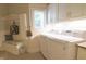 Bright laundry room featuring modern appliances, built-in storage, and a convenient bench at 1614 Rosebud Ln # 83, Greenwood, IN 46143