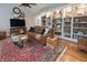 Comfortable living room featuring a large bookcase, hardwood floors, and a comfortable sofa at 1614 Rosebud Ln # 83, Greenwood, IN 46143