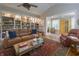 Open-concept living room featuring a large bookcase, leather seating, and a stylish rug at 1614 Rosebud Ln # 83, Greenwood, IN 46143