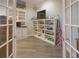Playroom featuring built-in shelves for displaying toys and games, with nice hardwood floors at 1614 Rosebud Ln # 83, Greenwood, IN 46143