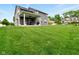 Expansive backyard with a lush green lawn and a covered patio area for relaxing and entertaining at 165 N Bend Dr, Greenwood, IN 46142