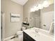 Bright bathroom with a dark vanity, white sink, and a glass-enclosed shower at 165 N Bend Dr, Greenwood, IN 46142
