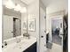 Well-lit bathroom with neutral walls, white cabinets, modern vanity, and a framed mirror at 165 N Bend Dr, Greenwood, IN 46142
