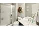 Bathroom featuring glass enclosed shower, floral accents, and a modern vanity at 165 N Bend Dr, Greenwood, IN 46142
